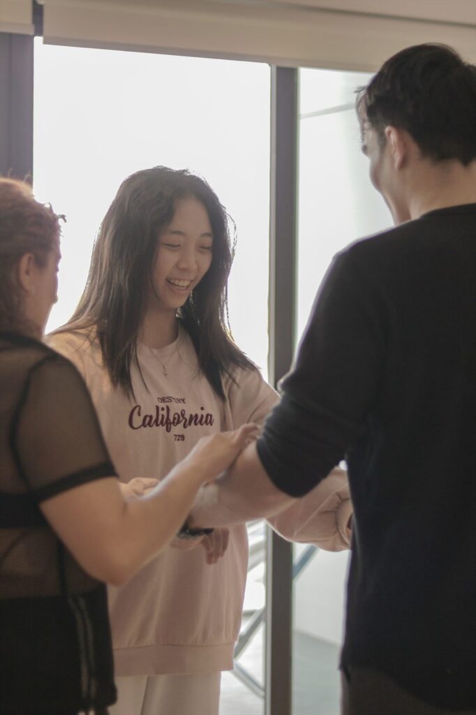 The teacher adjusts a couple's hold during a lesson